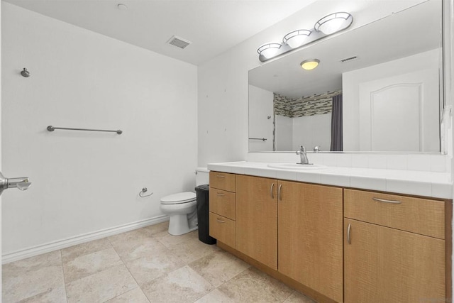 bathroom featuring toilet and vanity