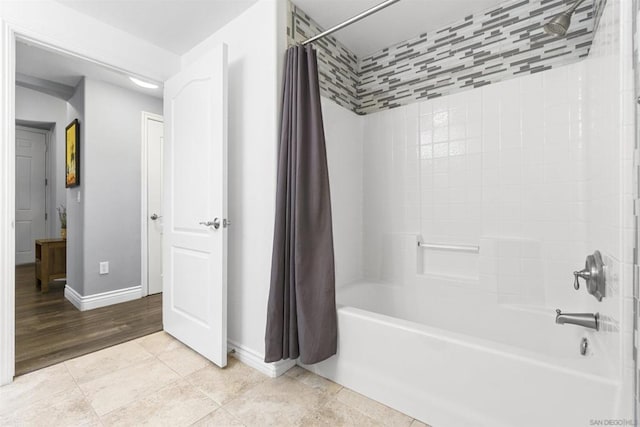 bathroom with shower / bath combination with curtain and tile patterned floors