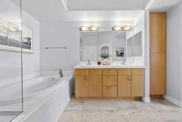 bathroom featuring tiled tub, tile patterned floors, and vanity