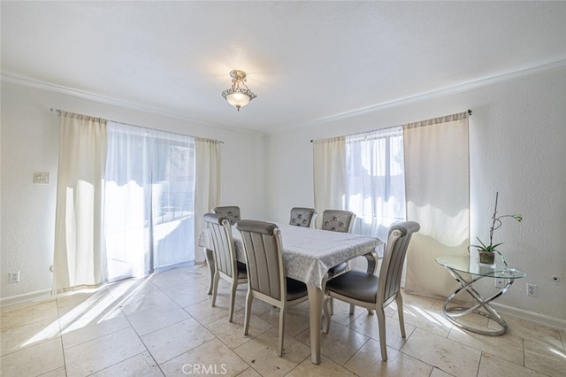 dining space with ornamental molding