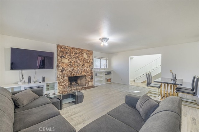 living room featuring a fireplace and light hardwood / wood-style flooring