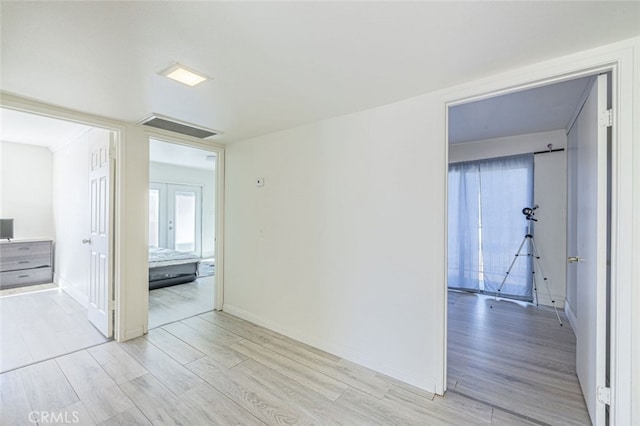 unfurnished room with light wood-type flooring