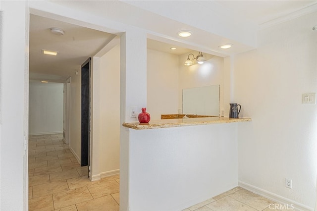 interior space with hanging light fixtures, light stone counters, and a chandelier