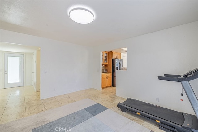 workout room with light tile patterned floors