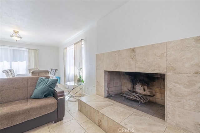 living room featuring a tile fireplace and ornamental molding