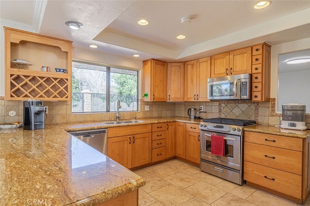 kitchen featuring a raised ceiling, decorative backsplash, sink, appliances with stainless steel finishes, and light tile patterned floors