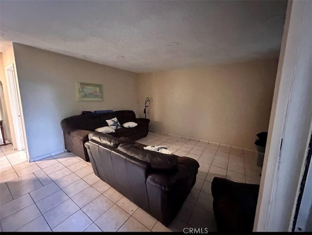 living room with a textured ceiling and light tile patterned flooring