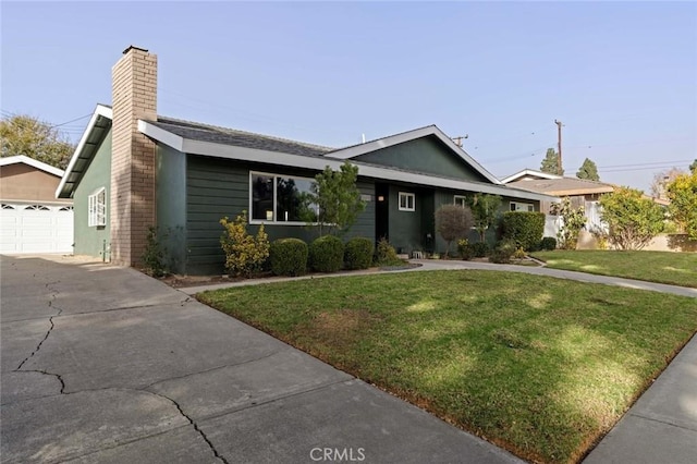 ranch-style house with a garage and a front lawn