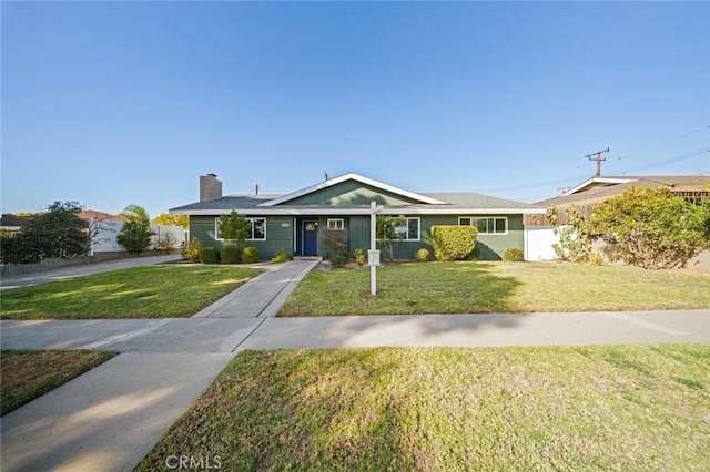 ranch-style home featuring a front yard