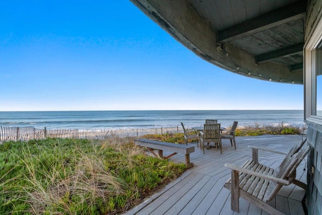 deck with a view of the beach and a water view