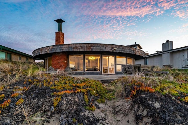 view of back house at dusk