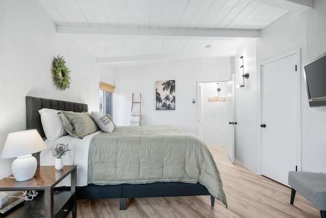 bedroom with wood-type flooring and beamed ceiling