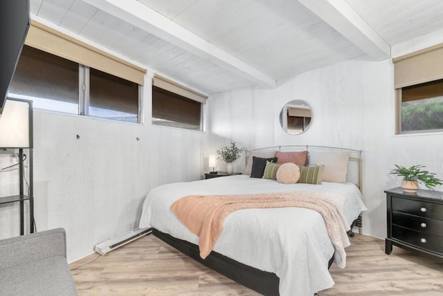 bedroom with light wood-type flooring and beamed ceiling