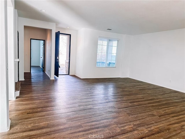 empty room with dark hardwood / wood-style floors