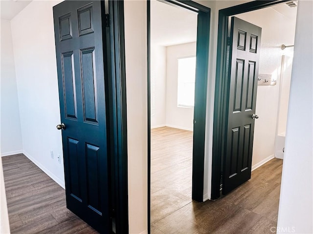 hallway with dark hardwood / wood-style floors