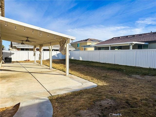 view of yard featuring ceiling fan, a patio area, and central air condition unit