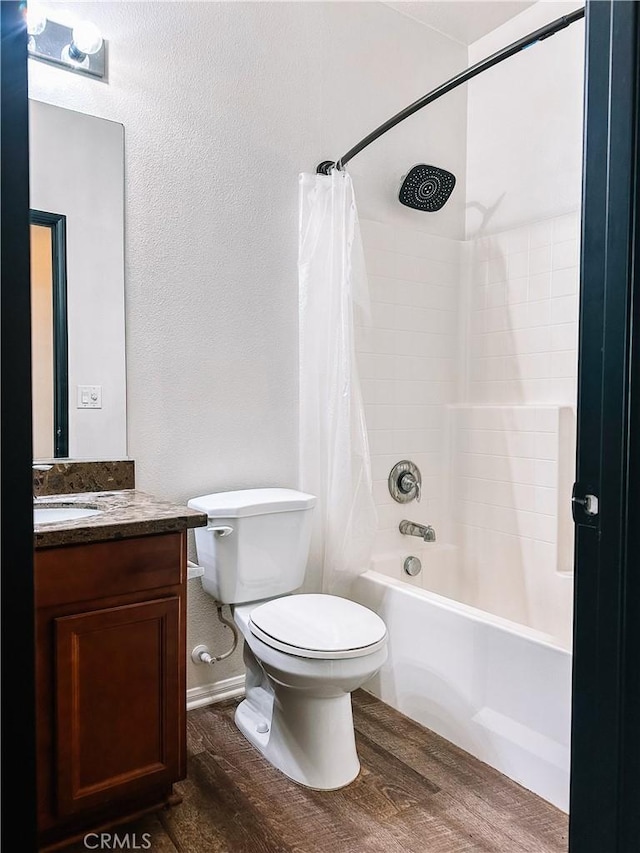 full bathroom featuring wood-type flooring, toilet, vanity, and shower / tub combo with curtain