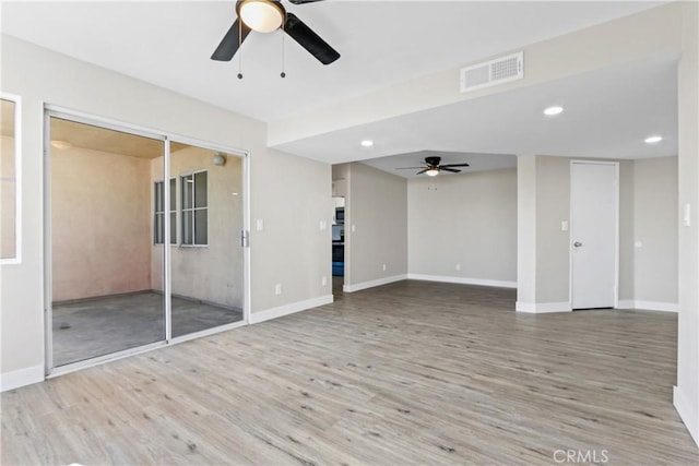 unfurnished living room featuring ceiling fan and light wood-type flooring