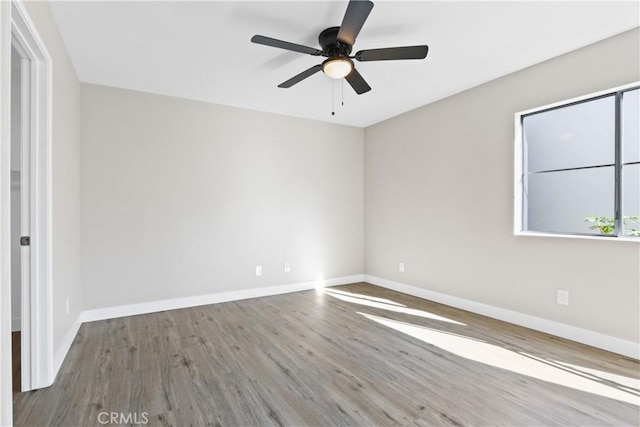 unfurnished room featuring ceiling fan and hardwood / wood-style floors