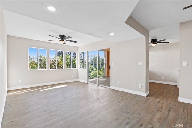 empty room featuring ceiling fan and hardwood / wood-style floors