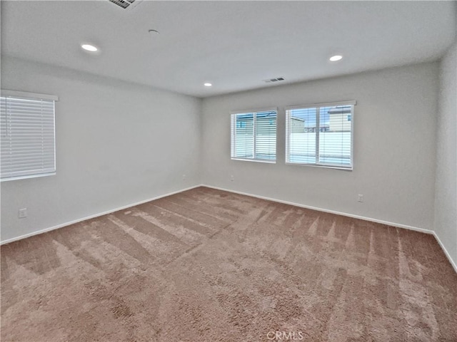 unfurnished room featuring baseboards, carpet flooring, visible vents, and recessed lighting