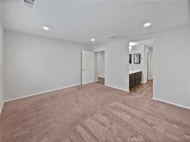 unfurnished bedroom with recessed lighting, baseboards, visible vents, and light colored carpet