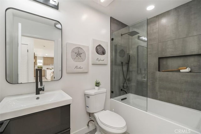 full bathroom with toilet, bath / shower combo with glass door, and vanity