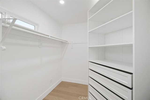 spacious closet with light hardwood / wood-style floors