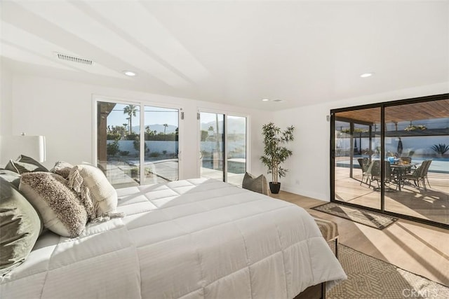 bedroom with access to exterior and light wood-type flooring