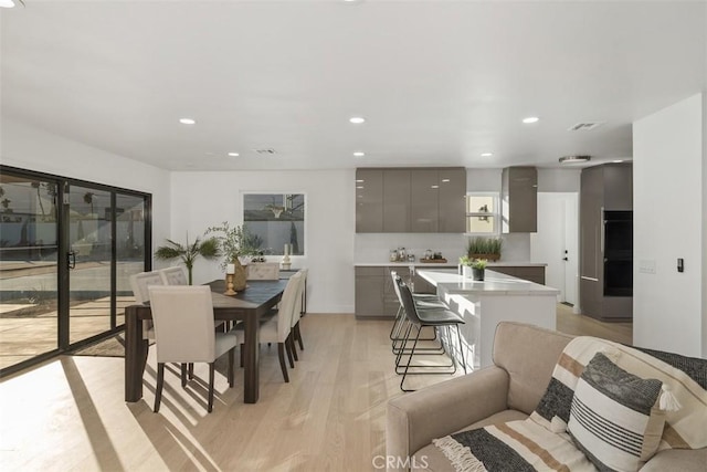 dining room with light wood-type flooring and plenty of natural light