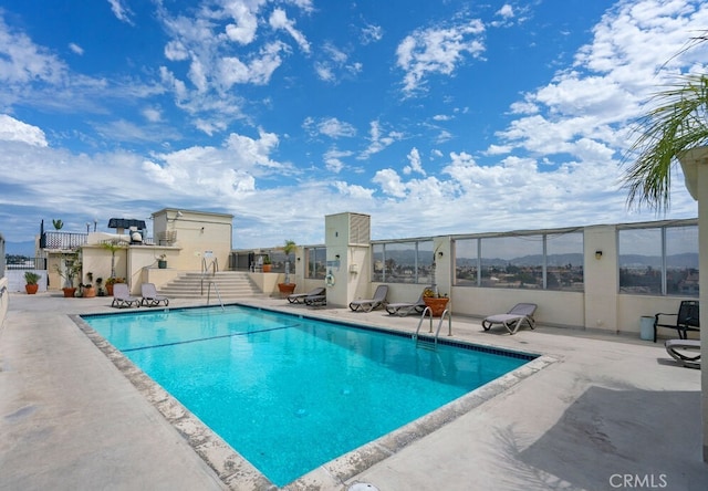 view of swimming pool featuring a patio area