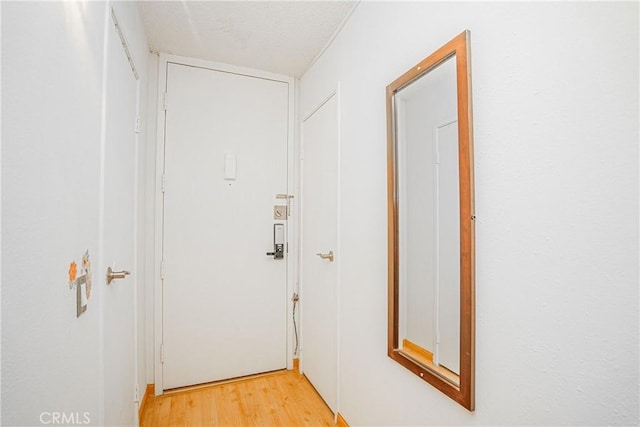 corridor with light wood-type flooring