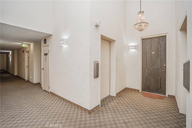 foyer entrance with a high ceiling and elevator