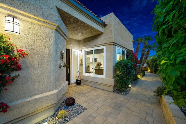 entrance to property with a patio area