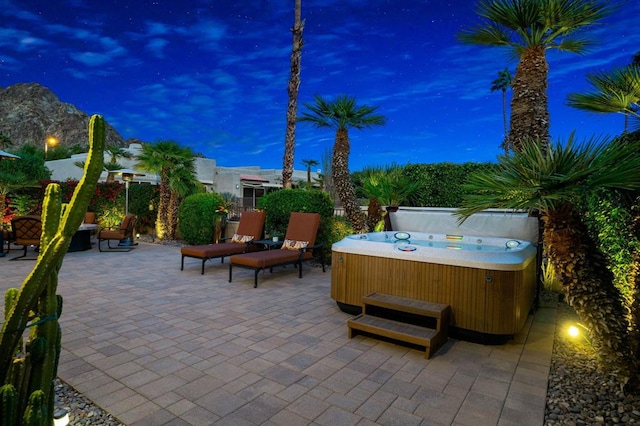 patio terrace at dusk with a hot tub