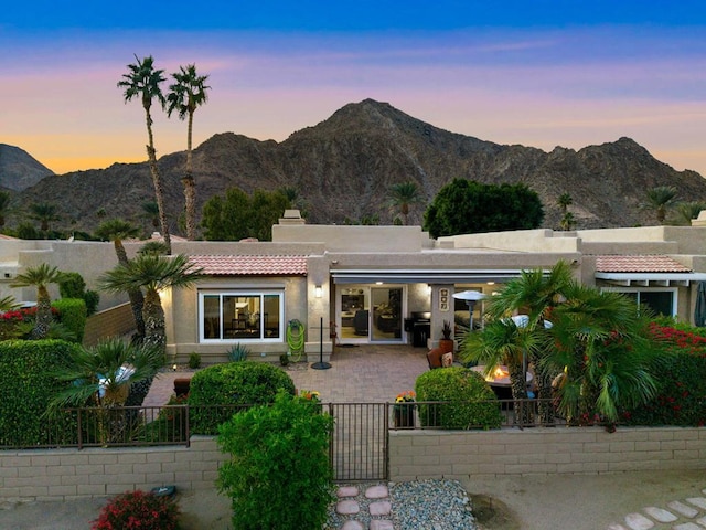 back house at dusk featuring a mountain view