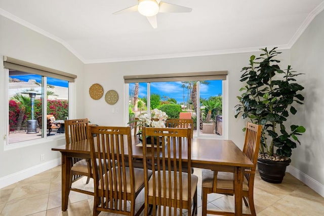 dining room featuring lofted ceiling, light tile patterned floors, ceiling fan, and crown molding