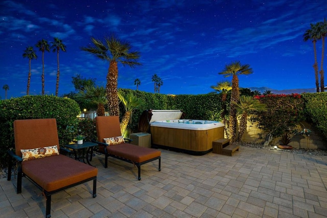 patio terrace at dusk with a hot tub