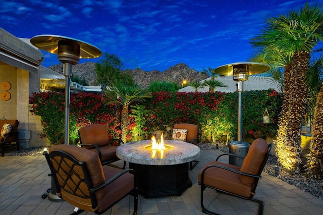 patio terrace at dusk featuring an outdoor fire pit