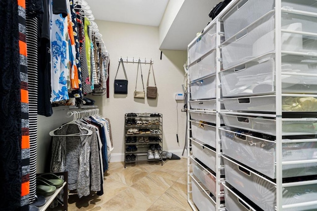 spacious closet featuring light tile patterned floors