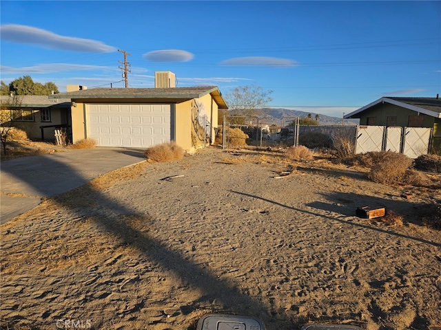 view of side of property featuring a mountain view and a garage