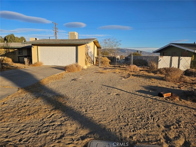 view of home's exterior with a garage and a mountain view