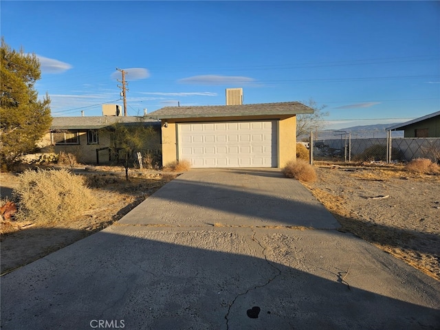 view of front of property with a garage and a mountain view