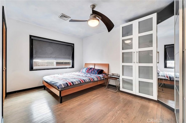 bedroom with ceiling fan and wood-type flooring