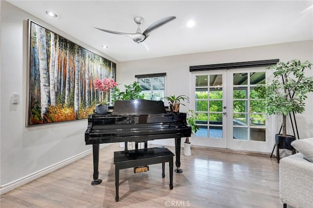 misc room with ceiling fan, light hardwood / wood-style floors, and french doors