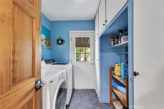 laundry area featuring washer and dryer and cabinets