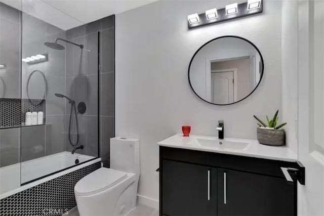 full bathroom featuring toilet, vanity, and tiled shower / bath