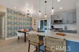 kitchen with decorative light fixtures and gray cabinets