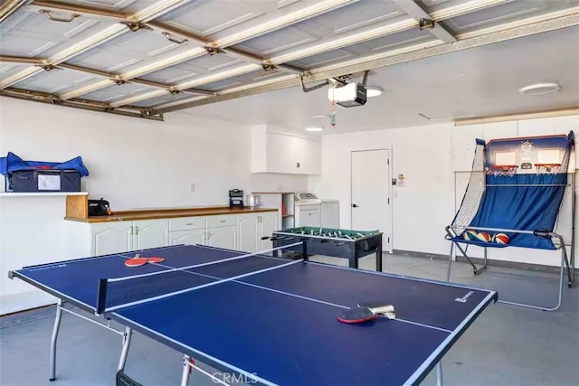 recreation room featuring concrete floors and washing machine and clothes dryer