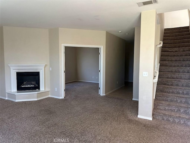 unfurnished living room featuring carpet floors